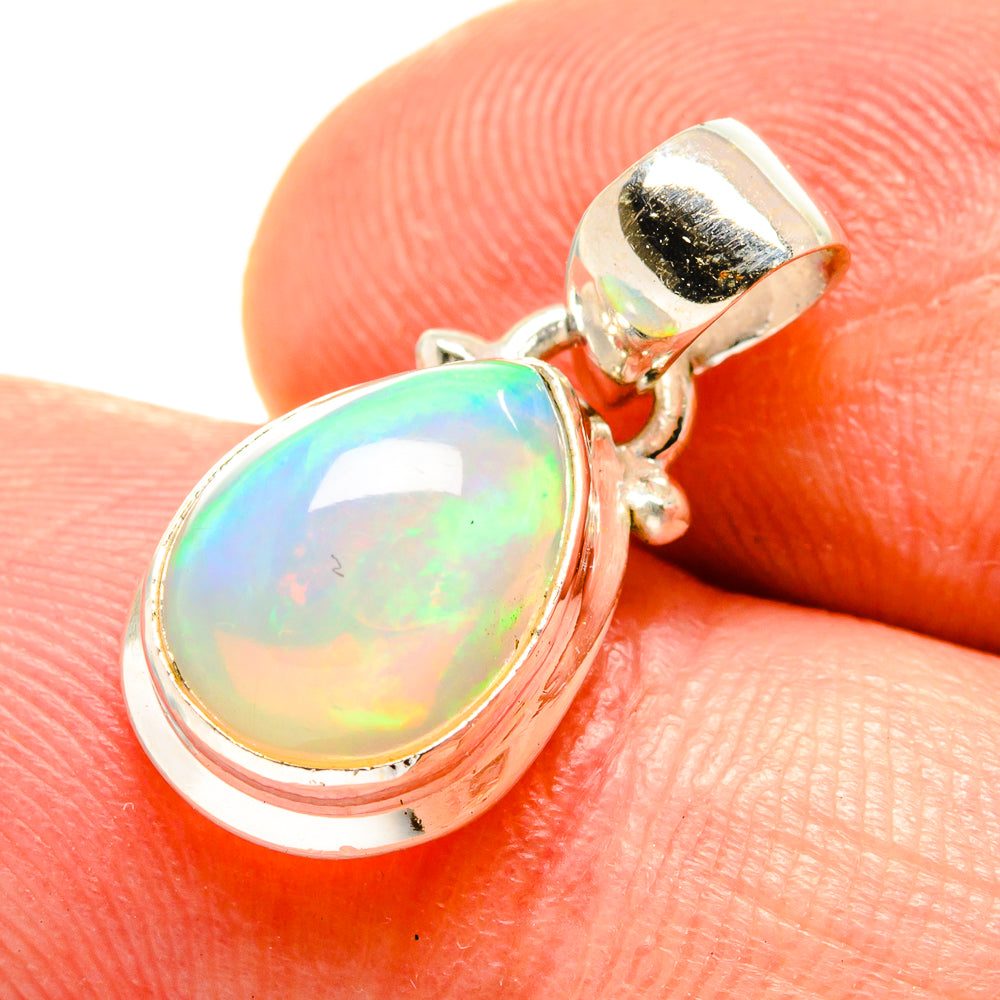 Opal pendant closeup: teardrop cabochon in silver bezel with loop bail