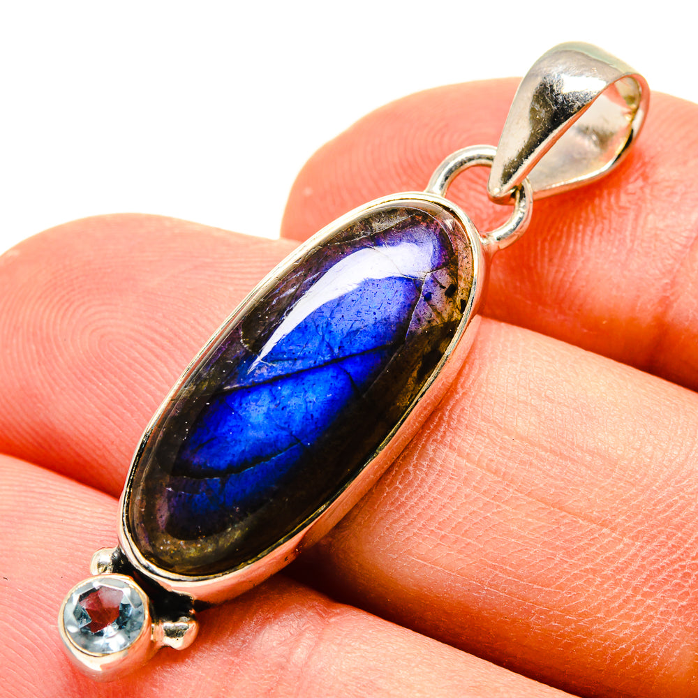 Oval labradorite pendant with blue flash and round blue topaz in sterling silver