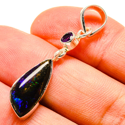 Sterling silver pendant with teardrop ammolite and small amethyst purple stone.