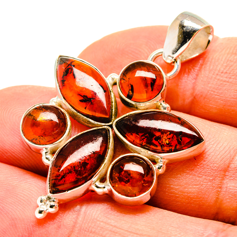 Amber pendant close-up: seven teardrop amber stones in 925 sterling silver setting