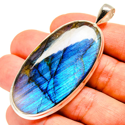 Oval labradorite pendant in sterling silver bezel with vivid blue flash, bail at top