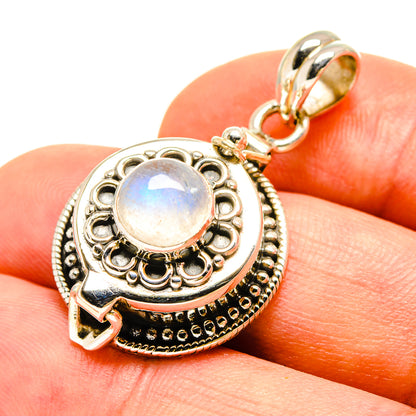 Sterling silver pendant with iridescent rainbow moonstone cabochon and detailed frame