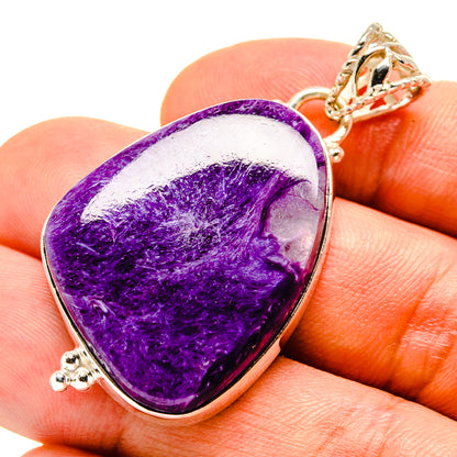 Purple charoite teardrop pendant with silver bezel and gold-tone chain