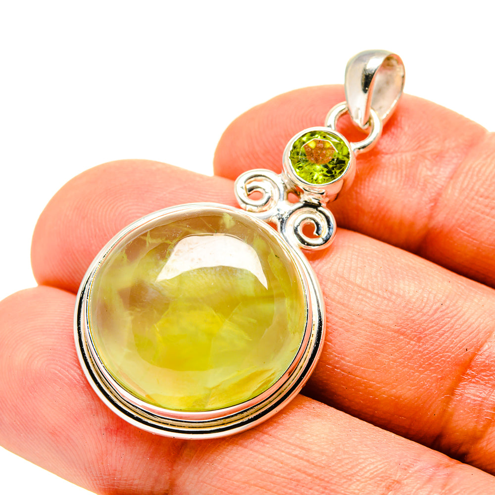 Sterling silver pendant close-up with round lime gemstone, small green bezel, loop bail