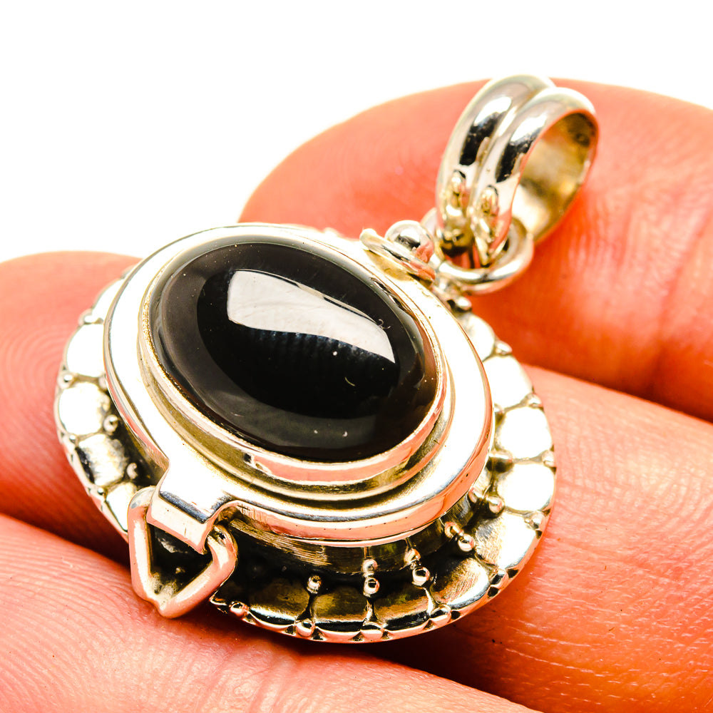 Black onyx poison pendant onyx oval stone with hinged bail, gold-tone frame