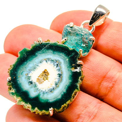 Solar quartz and fluorite pendant, green-blue slice with gold-toned core, silver bail.