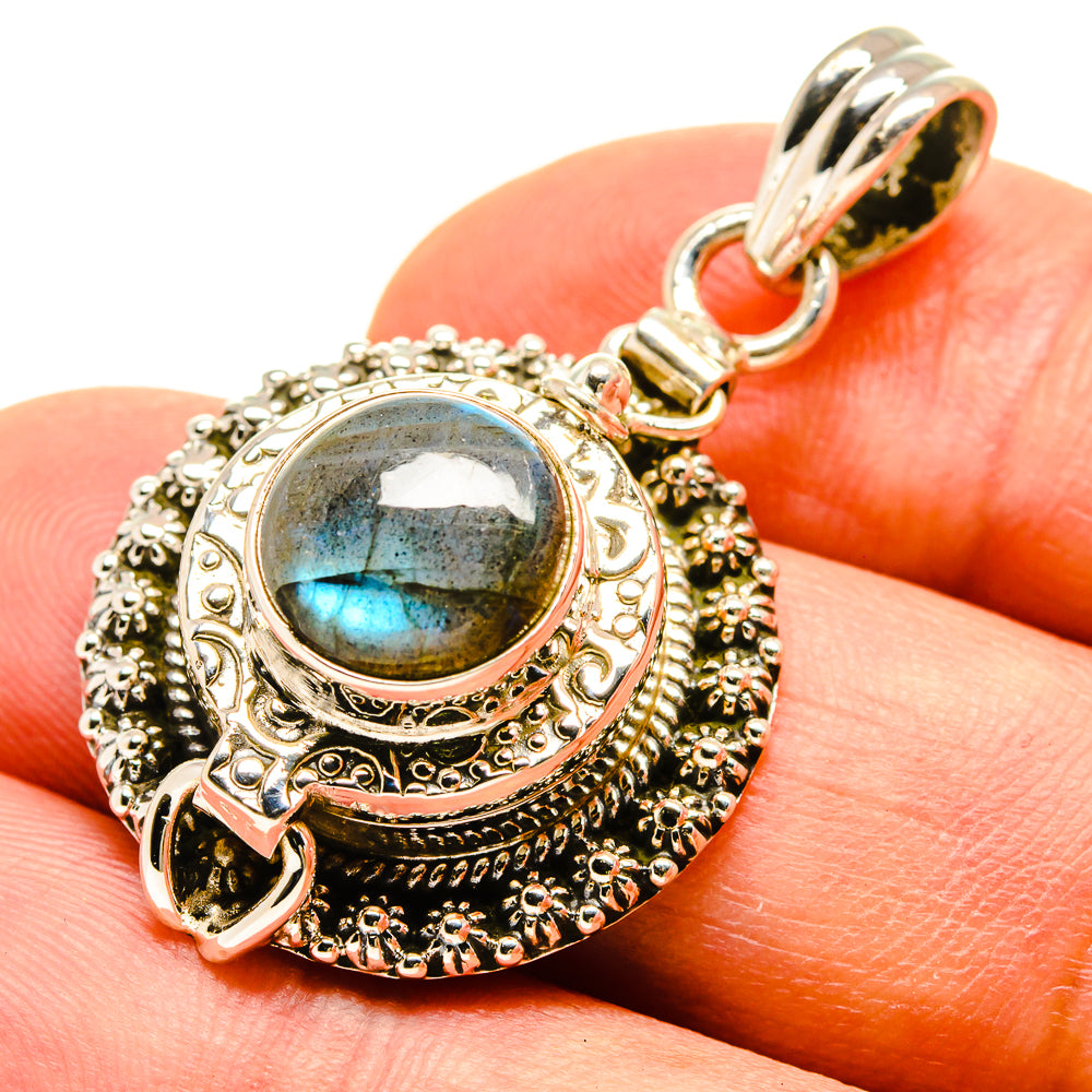 Ornate sterling silver pendant with oval labradorite cabochon, round bail