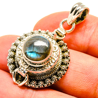 Ornate sterling silver pendant with oval labradorite cabochon, round bail