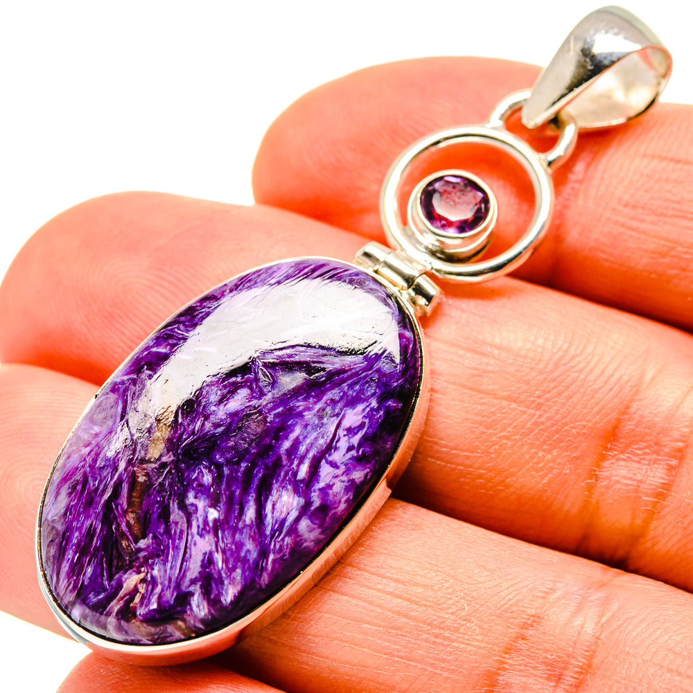 Oval charoite pendant with purple amethyst accent in sterling silver bezel setting