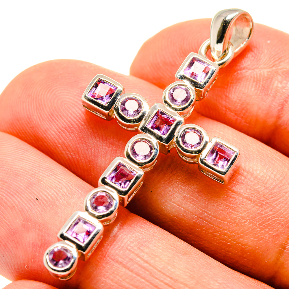 Silver cross pendant with faceted pink gemstone squares and round accents