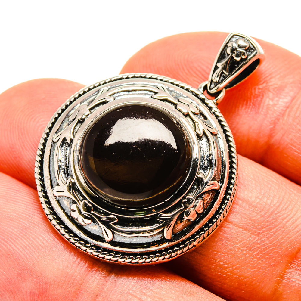 Smoky quartz pendant with oval-cut smoky stone, ornate sterling silver frame and bail
