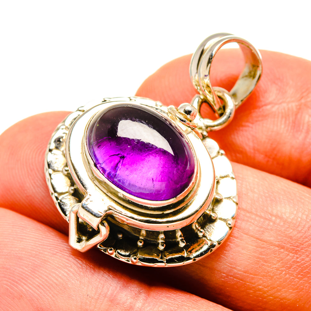 Oval amethyst cabochon pendant in ornate 925 sterling silver setting with loop bail