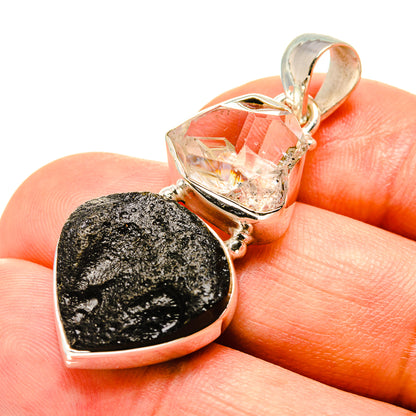 Sterling silver pendant with dark tektite heart and clear faceted stone