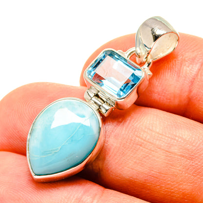 Sterling silver pendant close-up: oval larimar and rectangular blue topaz in prong settings