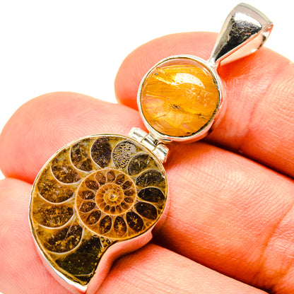 Sterling silver ammonite-style pendant with amber rutilated quartz center and fossil inlay