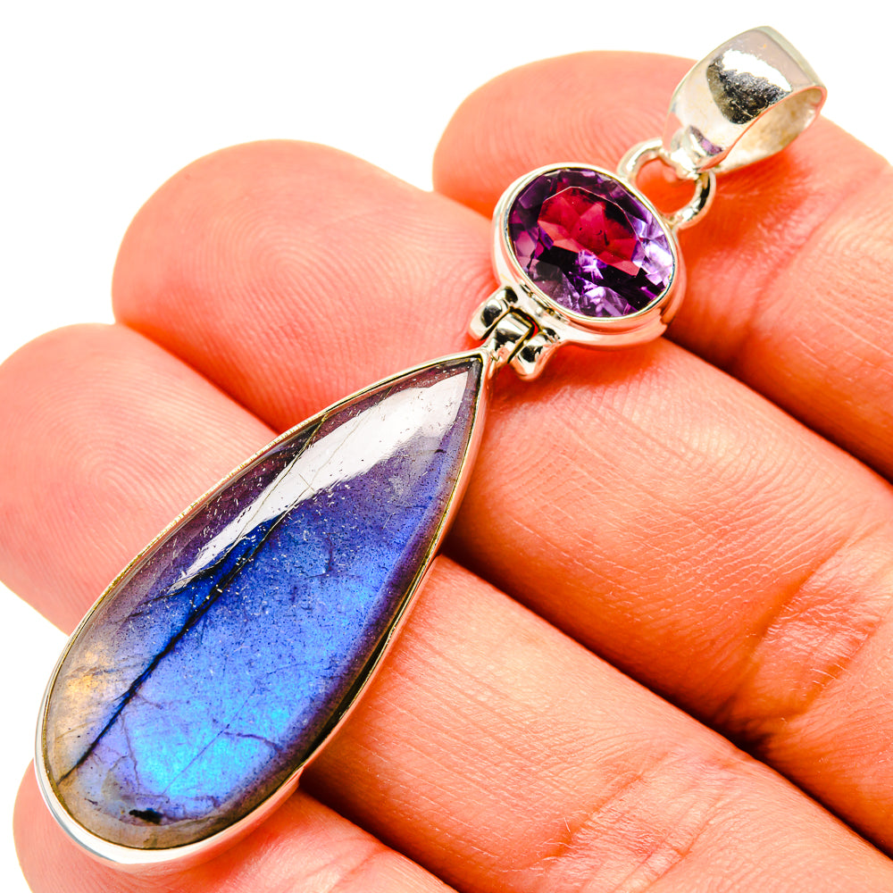 Amethyst and labradorite pendant close-up, gold-tone metal with purple cabochon