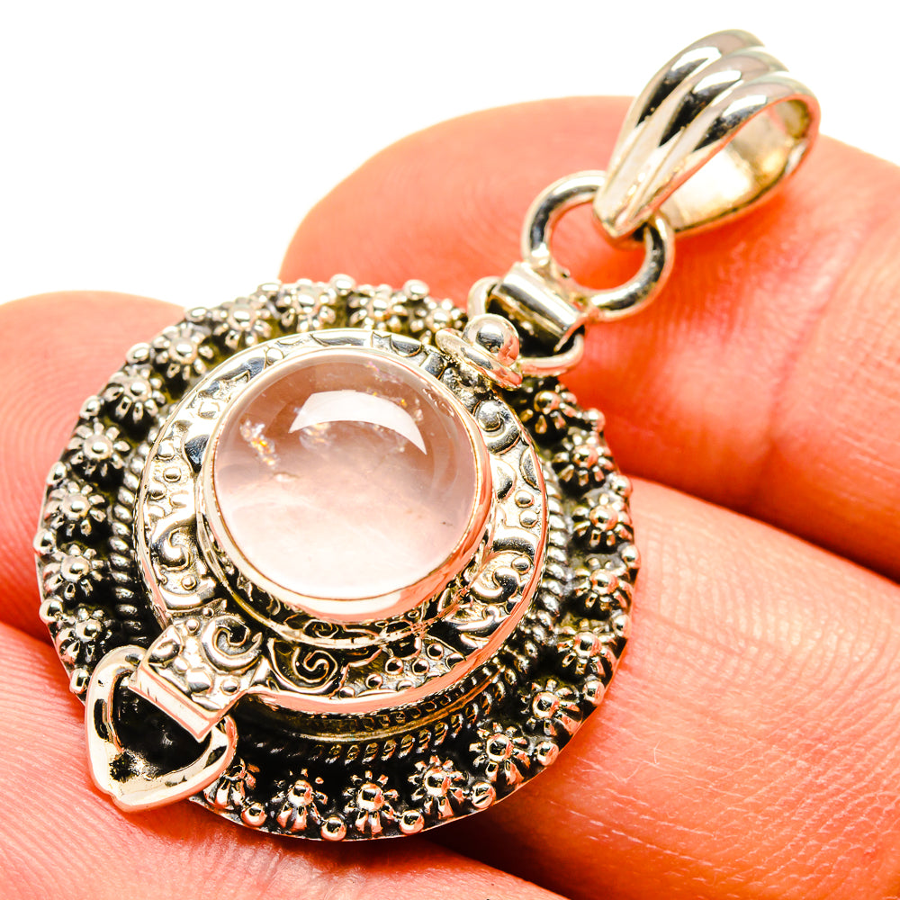 925 sterling silver pendant with ornate filigree and oval pink rose quartz crystal