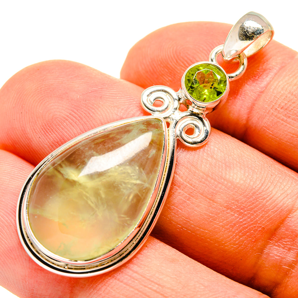 Sterling silver pendant with pear-shaped pale green gemstone and round green accents