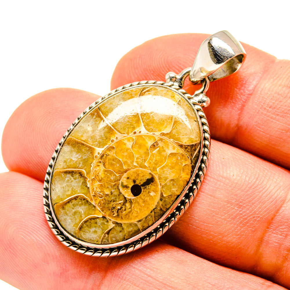 Ammonite fossil pendant in 925 sterling silver with oval amber cabochon and loop bail