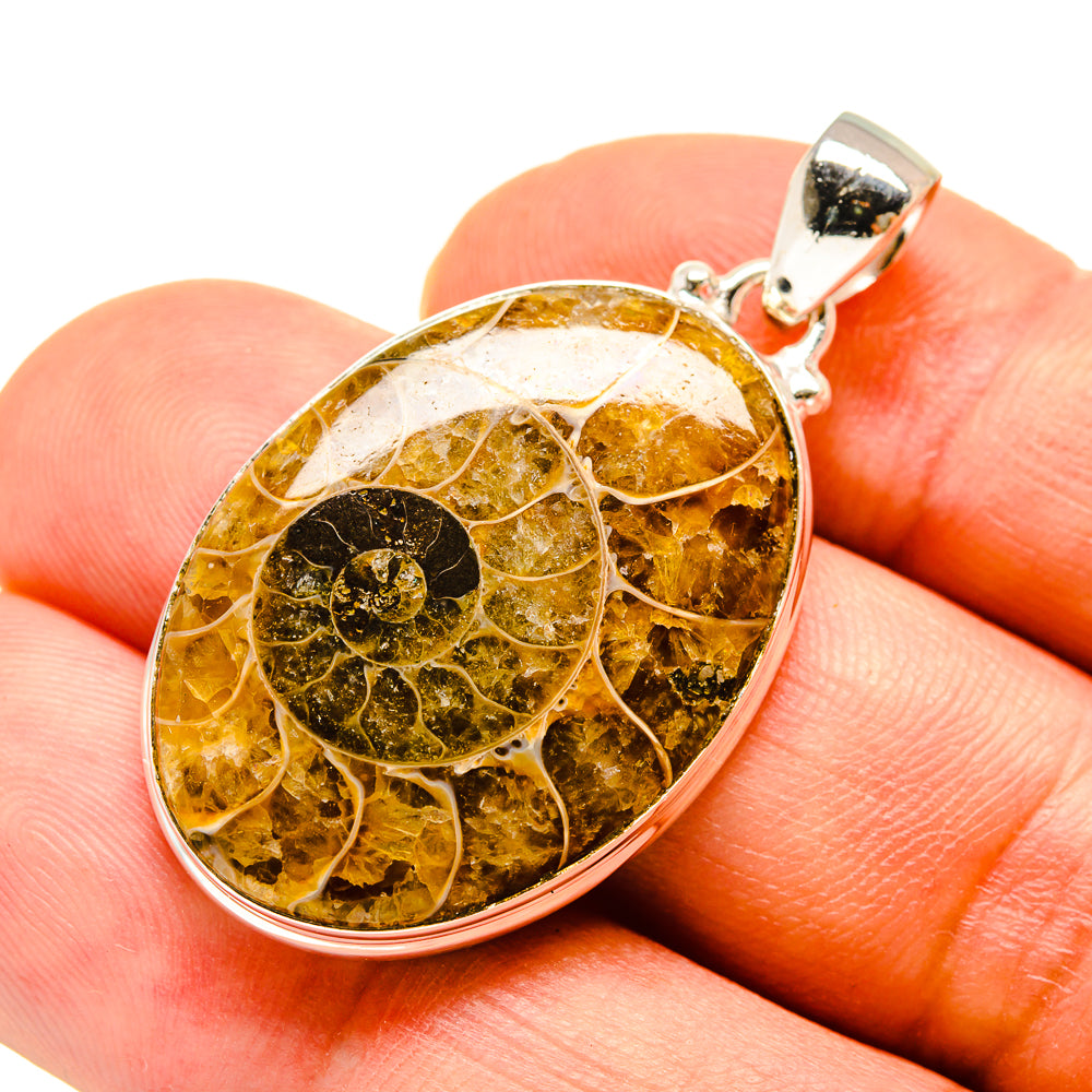 Ammonite fossil pendant in amber-toned stone with 925 sterling silver bezel and bail