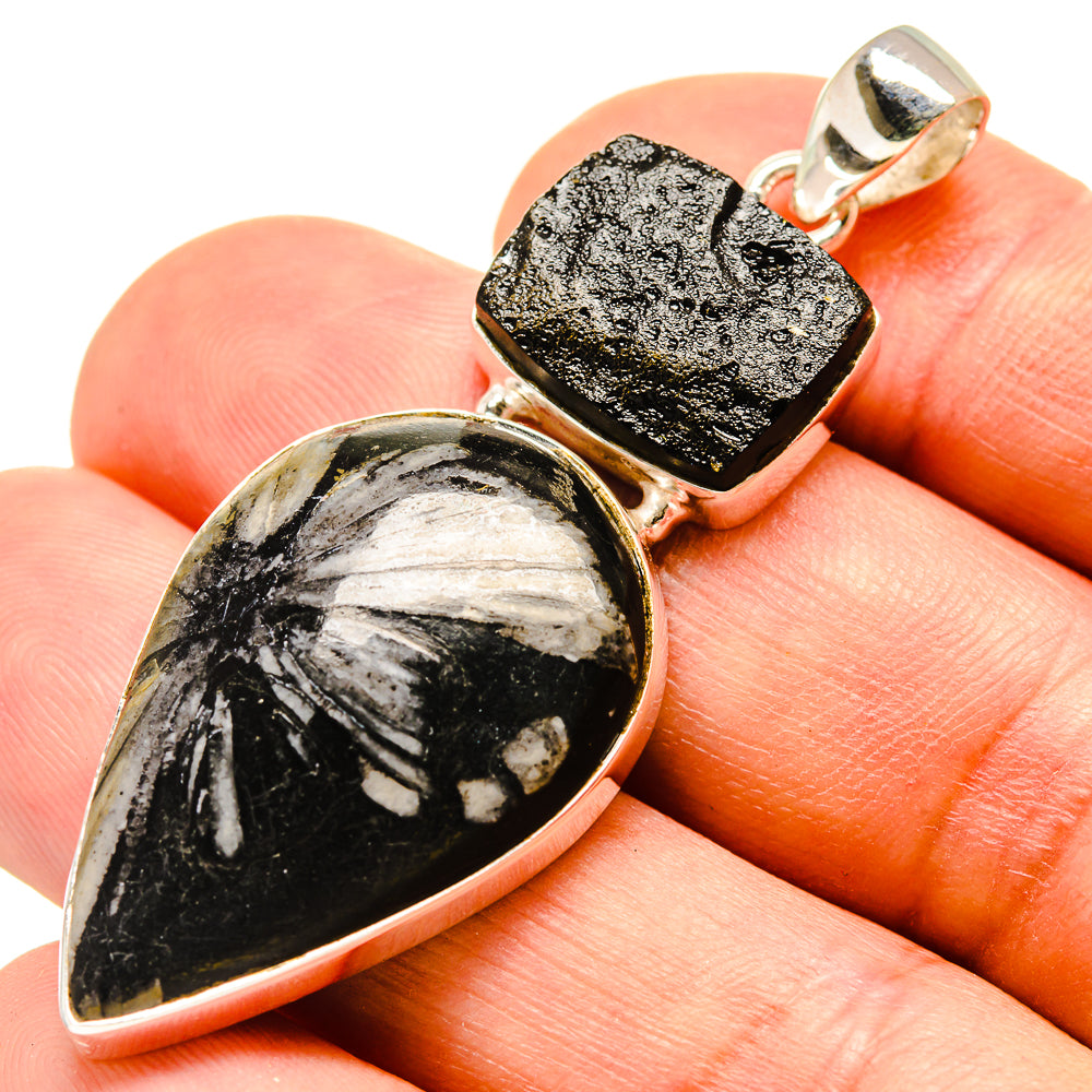 Teardrop chrysanthemum stone pendant on sterling silver setting with square tektite, on hand