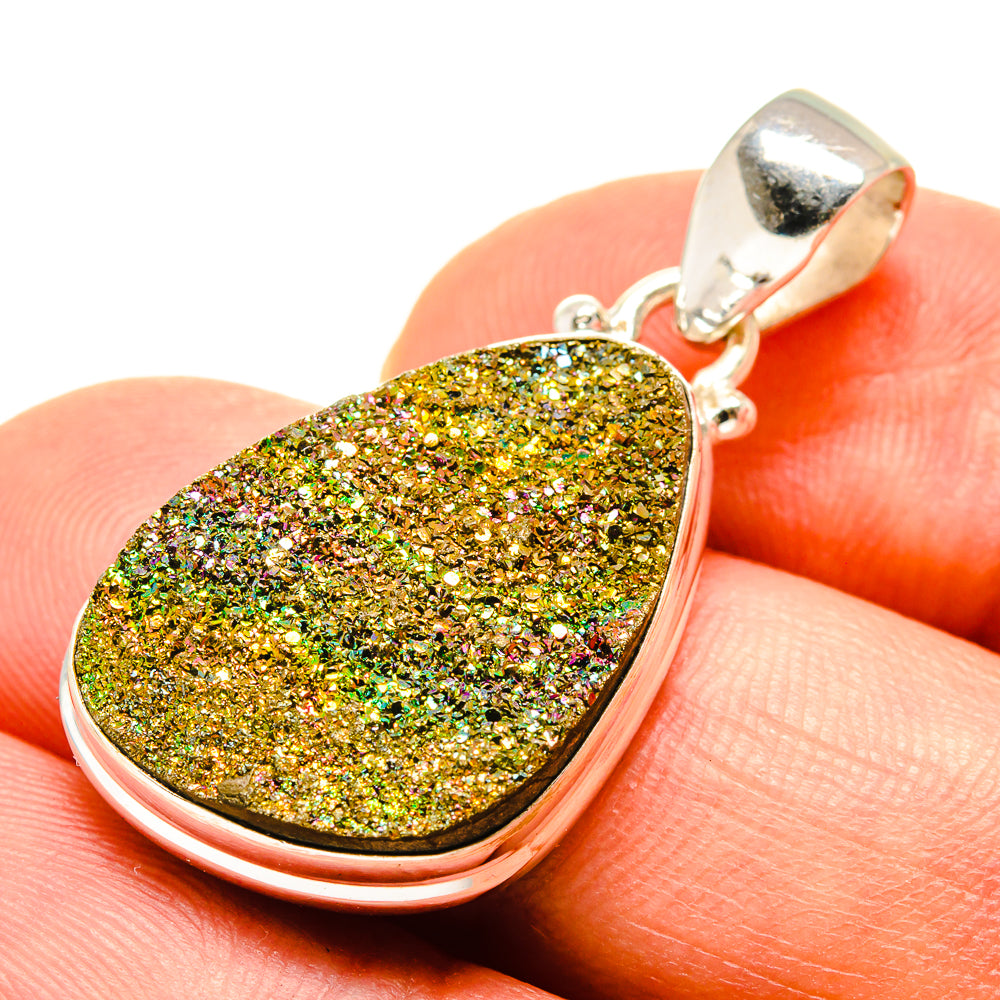 Teardrop druzy pendant close-up with gold green sparkle stone in silver bezel, bail