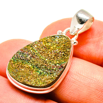Teardrop druzy pendant close-up with gold green sparkle stone in silver bezel, bail