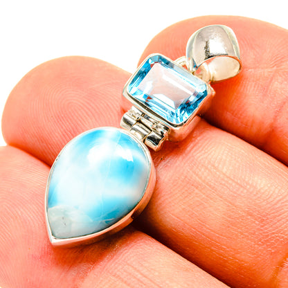 Sterling silver pendant showing square blue topaz and oval larimar gemstones