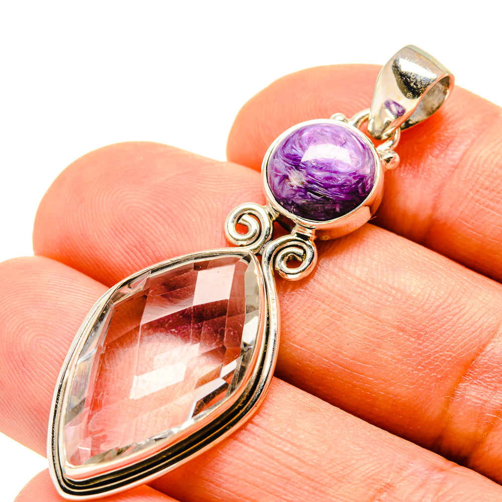 Sterling silver pendant with purple charoite cabochon and faceted clear oval quartz drop