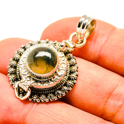 Moss agate pendant in ornate sterling silver with green cabochon and bail