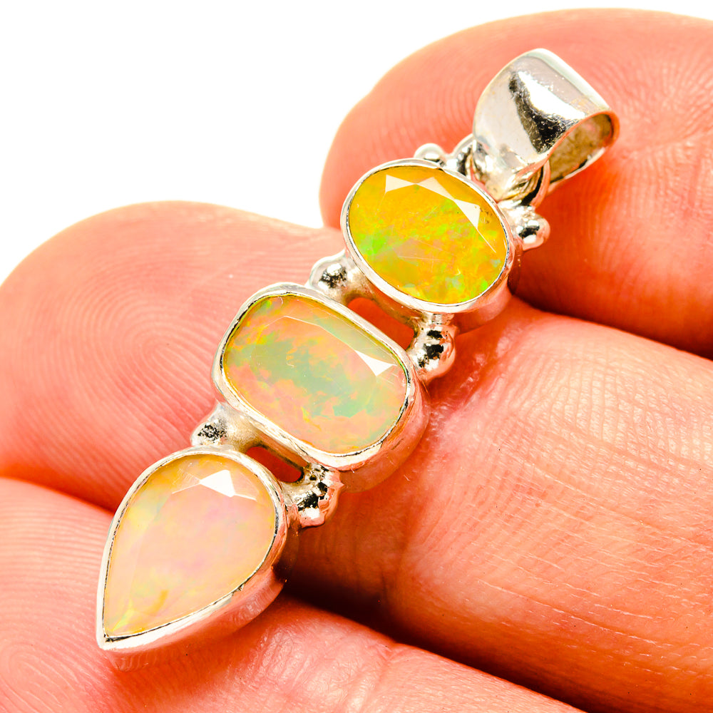 Opal pendant close-up with three gold-toned opal stones and silver bezel