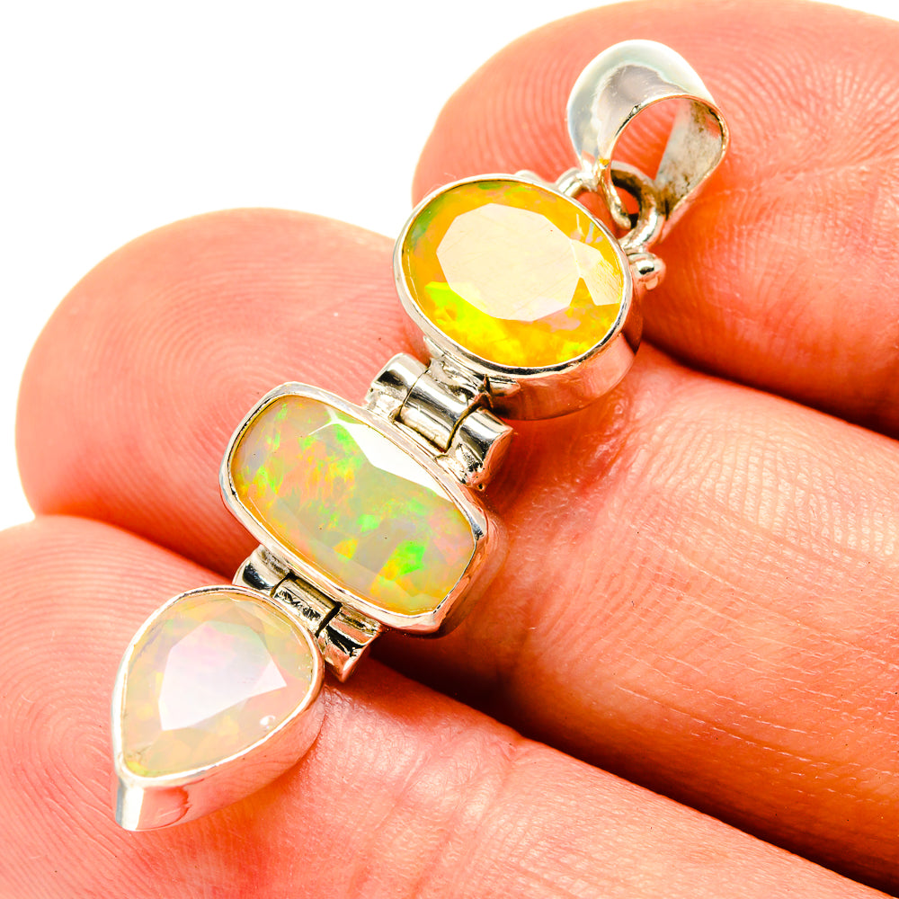 Sterling silver opal pendant with three faceted stones in yellow, green, and pink.