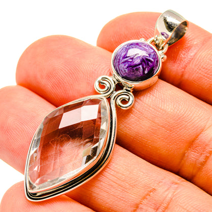 Sterling silver pendant close-up with purple cabochon and faceted crystal teardrop