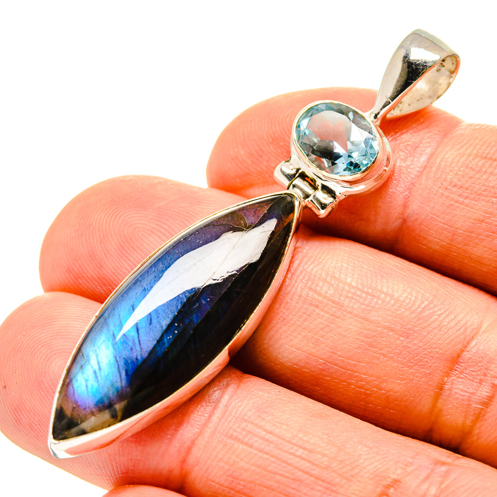Sterling silver pendant with blue topaz and iridescent labradorite marquise stone