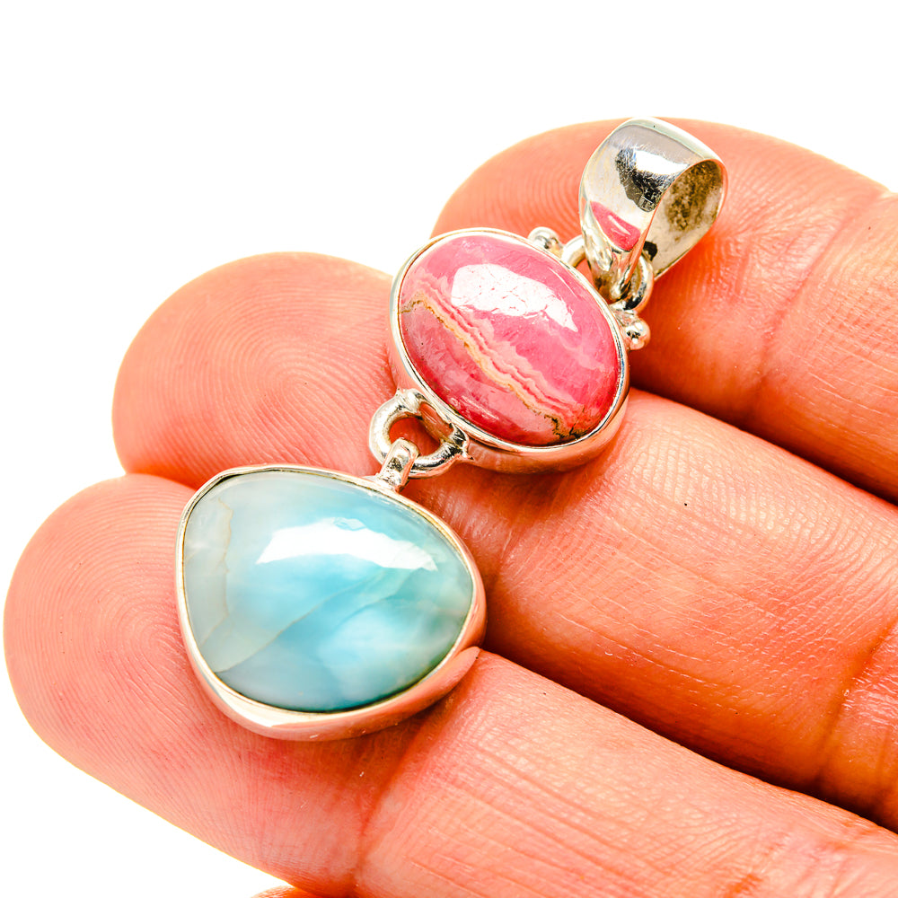 Sterling silver linked pendants with oval pink and oval blue gemstones.