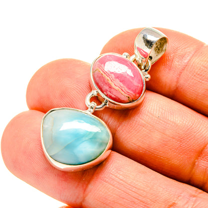 Sterling silver linked pendants with oval pink and oval blue gemstones.