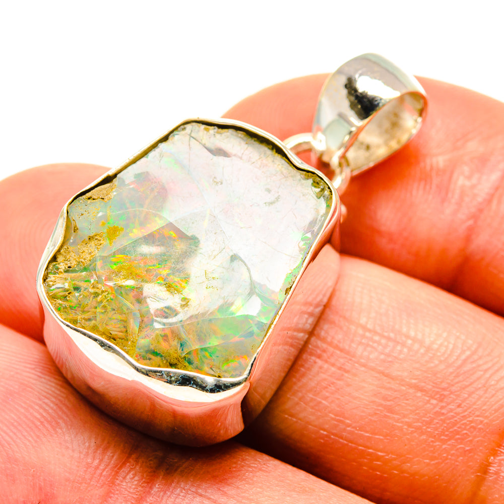 Rough Ethiopian opal pendant closeup, 925 sterling silver bezel, iridescent flashes