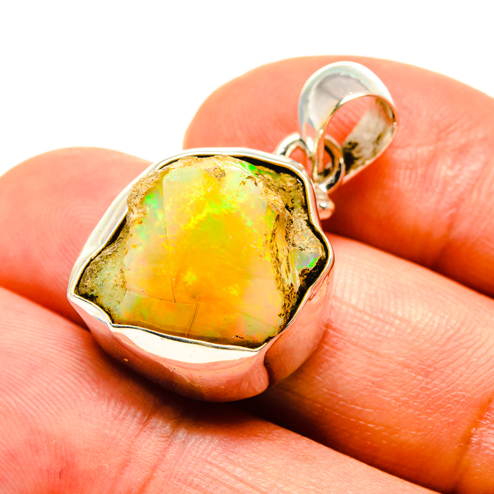 Rough Ethiopian opal pendant in 925 sterling silver with yellow-green stone, close-up.