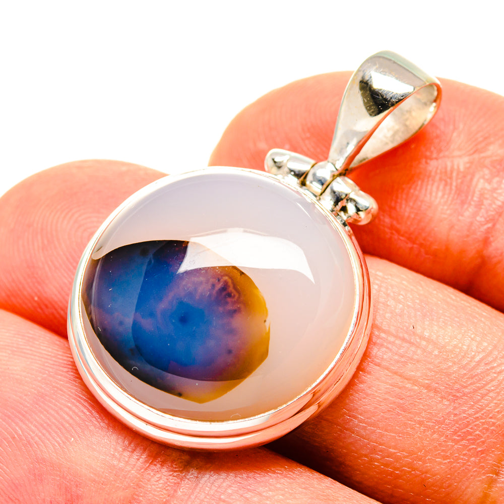 Round 925 sterling silver agate pendant with blue-and-orange cabochon, side bail