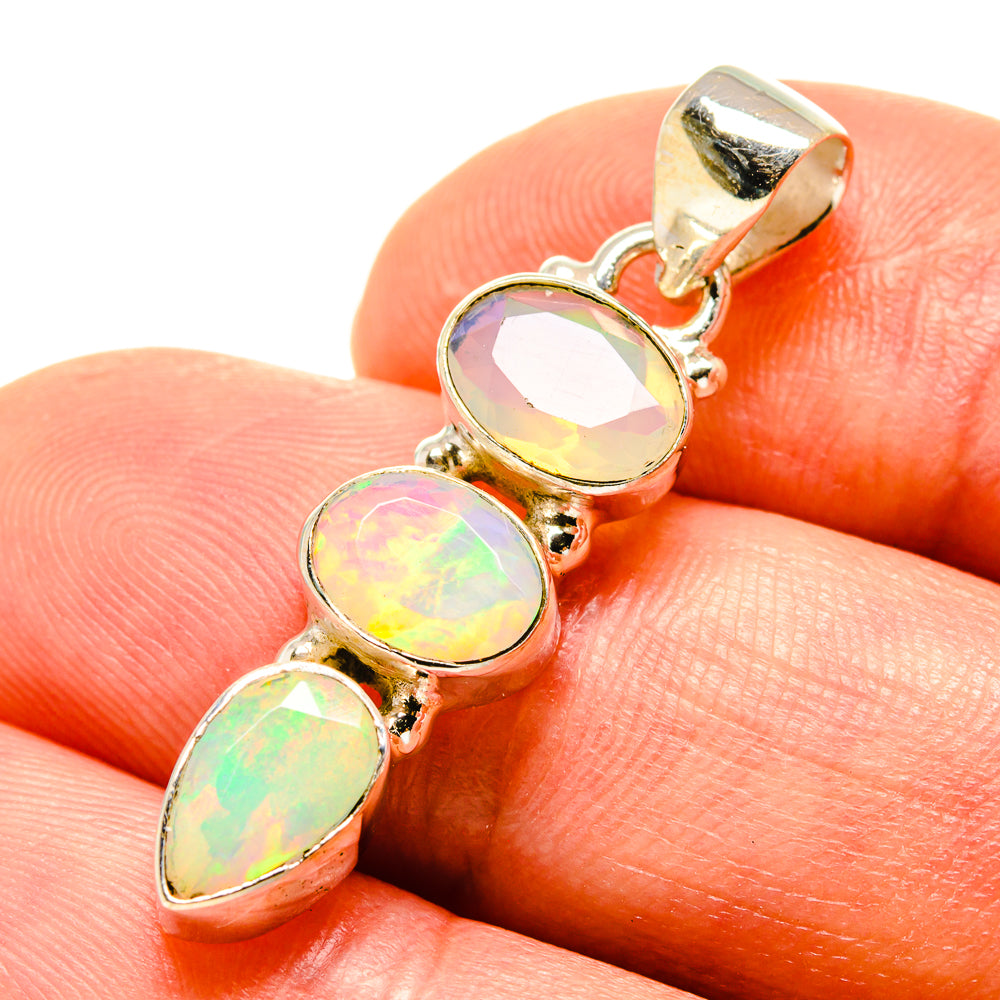Close-up sterling silver opal pendant with three iridescent oval Ethiopian opal stones