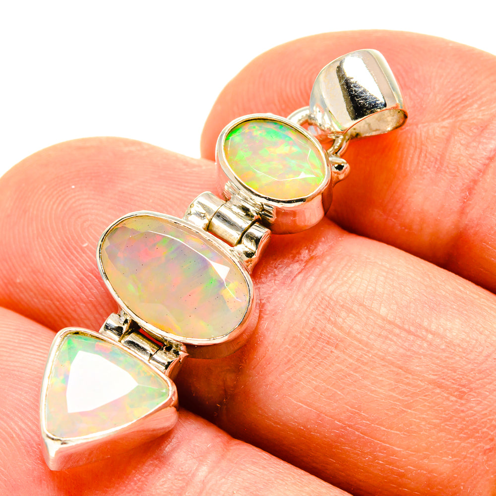Sterling silver opal pendant with three faceted oval cabochons and heart-cut centerpiece