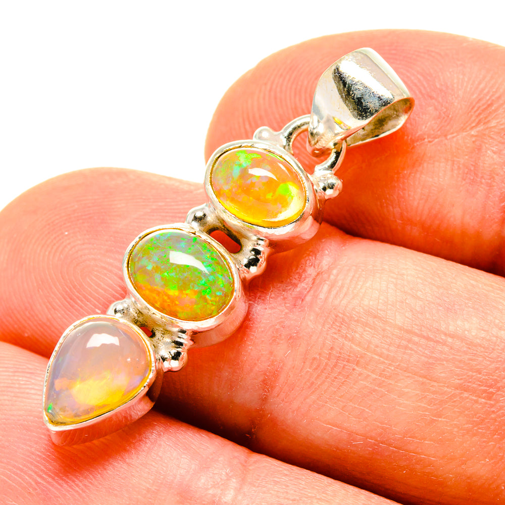 Sterling silver opal pendant with three oval Ethiopian opals in yellow, orange, and green