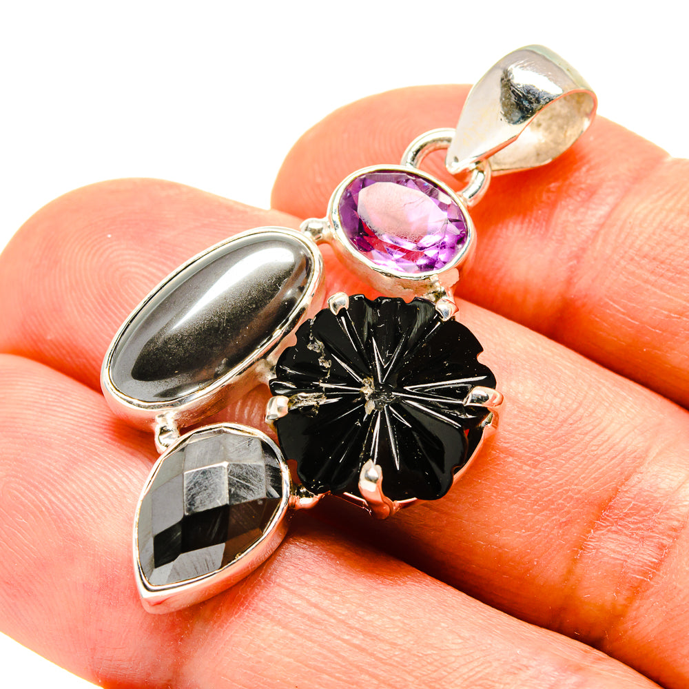 Sterling silver pendant with purple oval amethyst top and black floral center