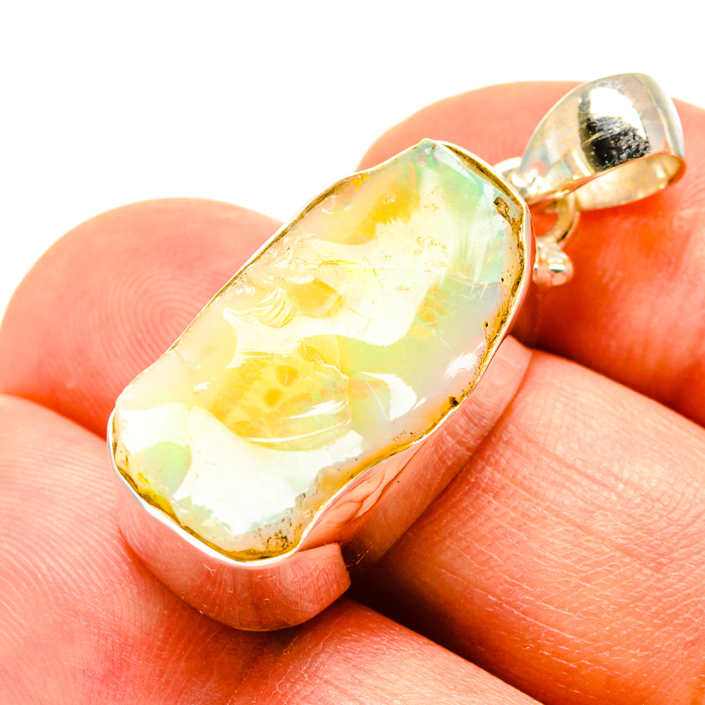 Sterling silver opal pendant with rough oval opal showing yellow, green, and orange tones