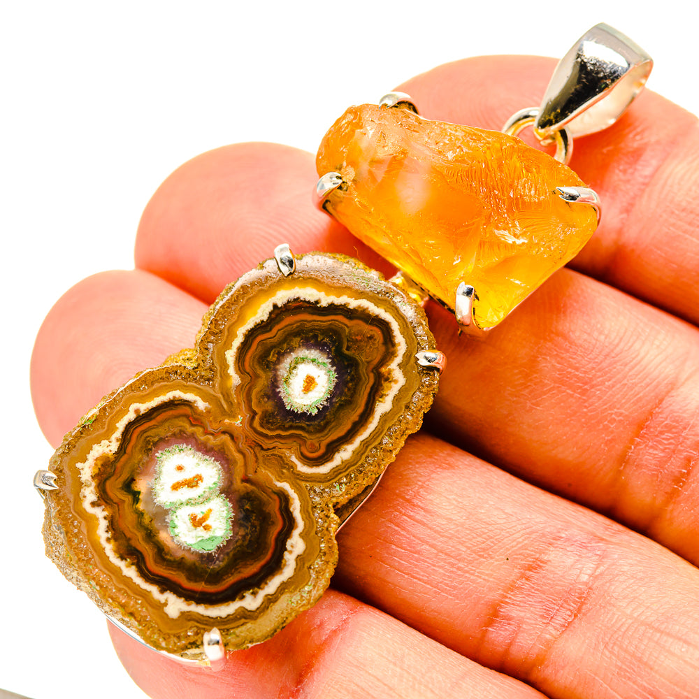 Orange solar quartz and citrine geode slice pendant in silver prongs, close view