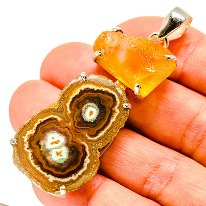 Orange solar quartz and citrine geode slice pendant in silver prongs, close view