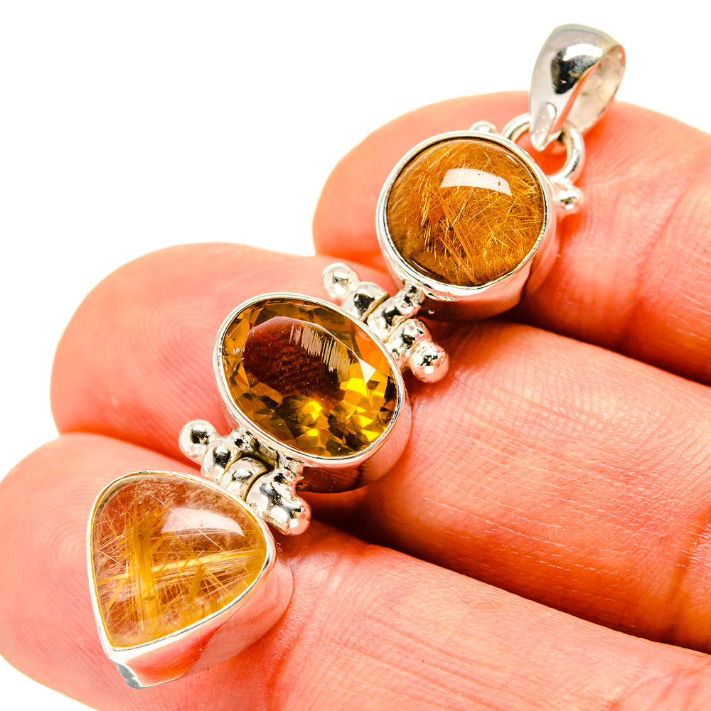 925 silver three-stone pendant close-up with orange and yellow heart and oval gemstones