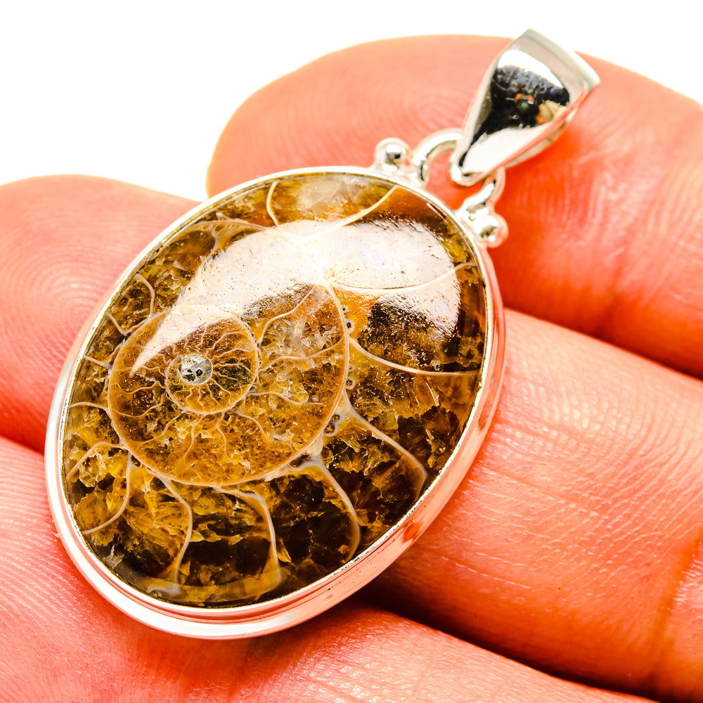 Ammonite fossil pendant in polished 925 sterling silver with round amber-brown cabochon