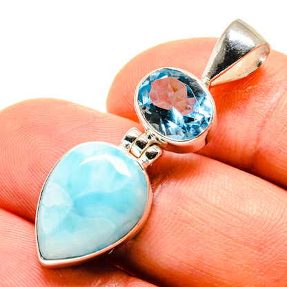 Sterling silver pendant with oval light-blue gemstone and round blue gemstone in bezel