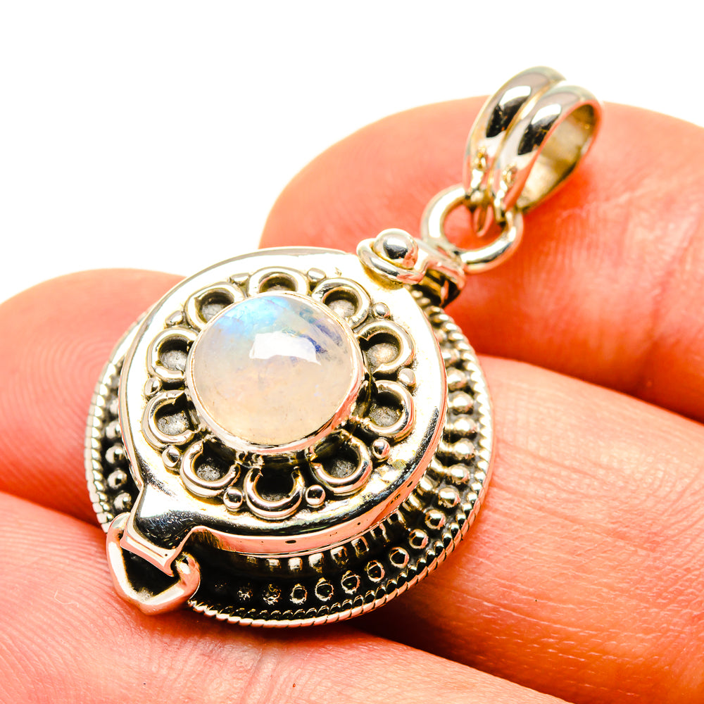 Sterling silver iridescent moonstone pendant with ornate round bezel and bail